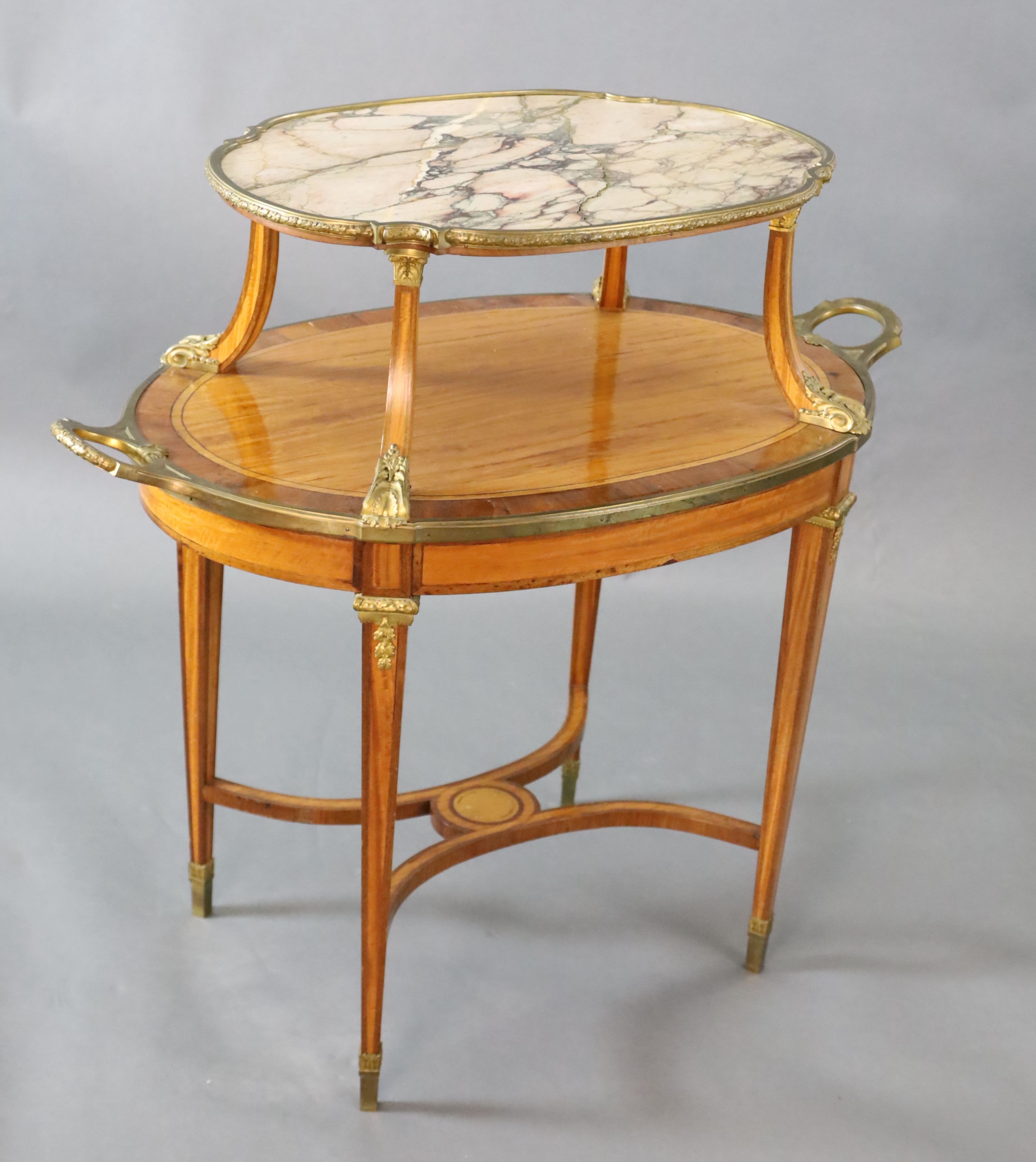 A late 19th century French satinwood, rosewood crossbanded and gilt metal mounted two tier oval etagere, W.3ft 4.5in. D.2ft H.3ft 3in.
